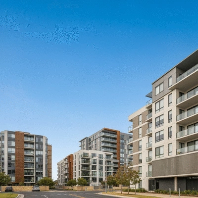 Modern apartment buildings in Adelaide against a clear sky, representing housing affordability and economic factors